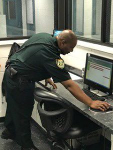 sheriff interacting with computer