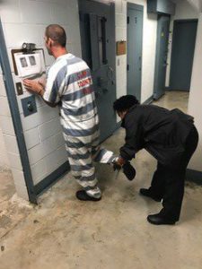 sheriff interacting with inmate