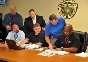 Clay County Sheriff's office employees in meeting around table
