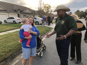 Sheriff interacting with mother and baby