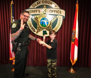 sheriff posing with kid