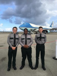 Youth program members in front of plane