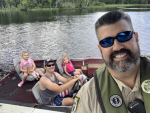 Sheriff taking picture with family on boat