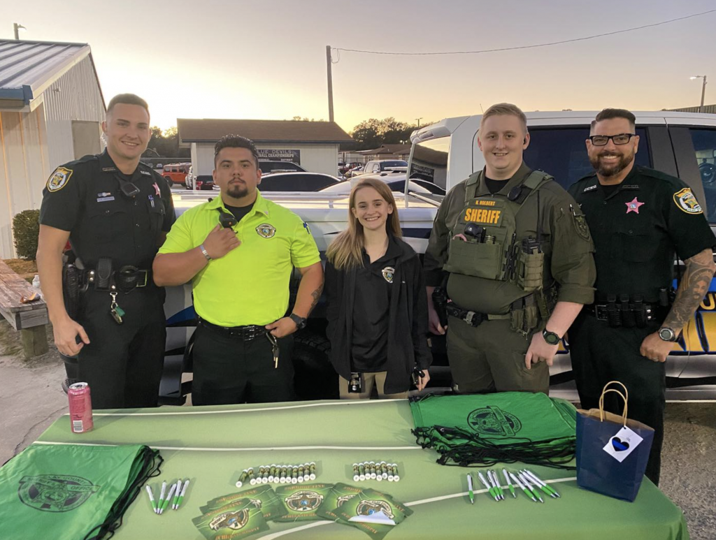 CCSO members stand behind a table at a recruiting event