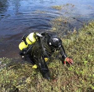 Dive team member in gear getting out of water