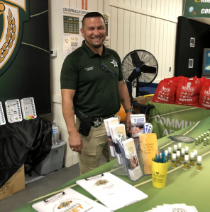 Deputy Bryon Maylon stands behind the CCSO booth at the Clay County Fair