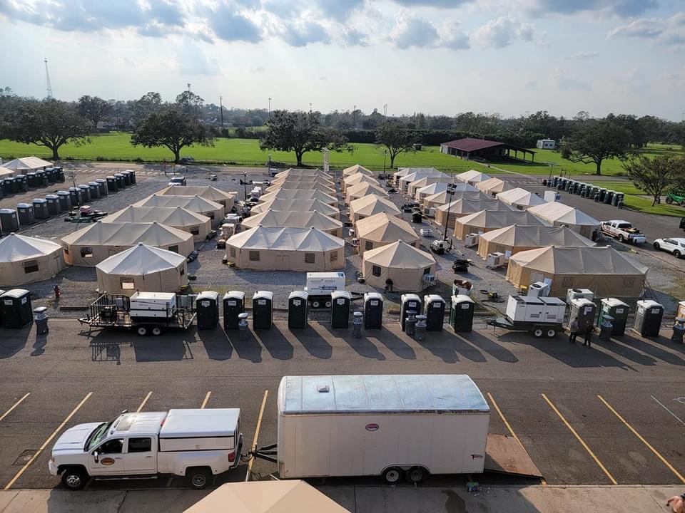 Trucks, tents, and vehicles are lined up in response to Hurricane Ida